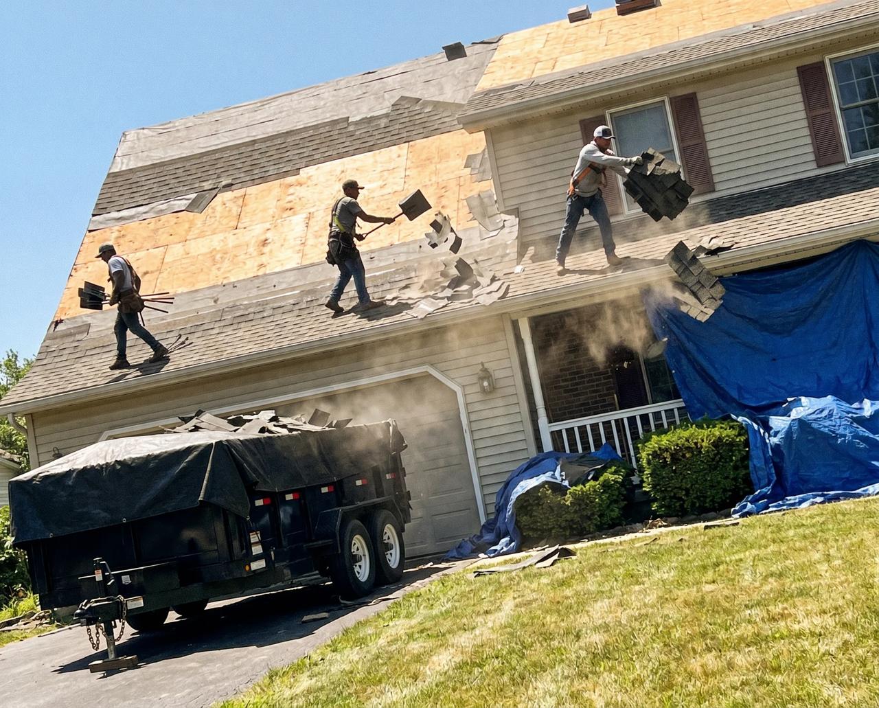 Crew tearing off old roof